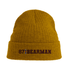 f111 merch mustard-yellow color beanie with bearman branding.